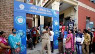 A police officer manages people who came to receive a dose of a coronavirus disease (COVID-19) vaccine outside a vaccination centre in Ahmedabad, India, June 30, 2021. REUTERS/Amit Dave