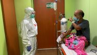 Cheras Sjarfi, a 28-year-old doctor, talks with a patient during her shift inside an isolation room at a government-run hospital, as coronavirus disease (COVID-19) cases surges in Jakarta, Indonesia, July 1, 2021. Picture taken July 1, 2021. REUTERS/Yuddy