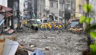 Police officers conduct search and rescue operation at a mudslide site caused by heavy rain at Izusan district in Atami, west of Tokyo, Japan July 4, 2021, in this photo taken by Kyodo. Kyodo/via REUTERS