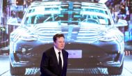 FILE PHOTO: Tesla Inc CEO Elon Musk walks next to a screen showing an image of Tesla Model 3 car during an opening ceremony for Tesla China-made Model Y program in Shanghai, China January 7, 2020. REUTERS/Aly Song/File Photo
