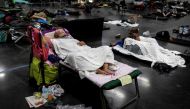 FILE PHOTO: People sleep at a cooling shelter set up during an unprecedented heatwave in Portland, Oregon, U.S. June 27, 2021. REUTERS/Maranie Staab/File Photo

