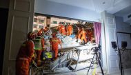 Rescue workers work at the site where a hotel building collapsed in Suzhou, Jiangsu province, China July 12, 2021. Picture taken July 12, 2021. China Daily via REUTERS 