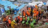 Rescue workers search for survivors after a residential house collapsed due to landslide caused by heavy rainfall in Mumbai, India, July 18, 2021. REUTERS/Niharika Kulkarni