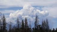 Smoke clouds rise as the Dixie Fire grows to over 18,000 acres in Plumas National Forest, California, U.S., July 18, 2021. REUTERS/David Swanson