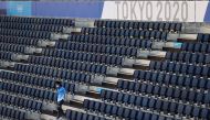 July 19, 2021 A volunteer walks in a stand REUTERS/Edgar Su