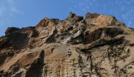 Senegalese rock climber Daouda Diallo is being lowered from a top of a rock wall at the Mamelles cliffs in Dakar, Senegal, June 27, 2021. Picture taken June 27, 2021.REUTERS/Cooper Inveen
