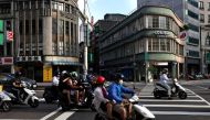 People wearing masks drive motorbikes in Taipei amid the Coronavirus disease (Covid-19) in Taiwan, June 30, 2021. REUTERS/Ann Wang/File Photo
