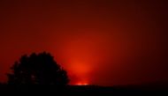 The Bootleg Fire glows in the distance, near Beatty, Oregon, U.S., July 13, 2021. Picture taken July 13, 2021. REUTERS/Mathieu Lewis-Rolland/File Photo