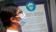 A woman wears a mask against the coronavirus disease (COVID-19), following the CDC recommendation that fully vaccinated Americans wear masks as the highly transmissible Delta variant has led to a surge in infections, as she enters the Disney Store in Time