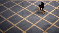 A person wearing a mask rides a bicycle of bike-sharing service on a street, almost a year after the start of the coronavirus disease (COVID-19) outbreak, in Wuhan, Hubei province, China December 17, 2020. REUTERS/Aly Song