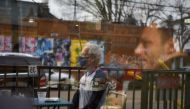 FILE PHOTO: Herb Pasternak wears a mask while dining outdoors as the state of Texas lifts its mask mandate and allows businesses to reopen at full capacity during the coronavirus disease (COVID-19) pandemic in Houston, Texas, U.S., March 10, 2021. REUTERS