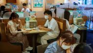 FILE PHOTO: People sit in a restaurant using plexiglass separators to protect customers from coronavirus (COVID-19) disease in the Shibuya area of Tokyo, Japan, July 29, 2021. REUTERS/Androniki Christodoulou/File Photo