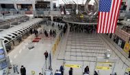 FILE PHOTO: Passengers walk through Terminal 1, after further cases of coronavirus were confirmed in New York, at JFK International Airport in New York, U.S., March 13, 2020. REUTERS/Shannon Stapleton
