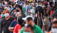People wearing protective masks queue outside the Central Vaccination Center as Thailand opens walk-in first dose of the AstraZeneca coronavirus disease (COVID-19) vaccination scheme for elders, people with a minimum weight of 100 kilograms and pregnant w