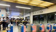 Media members stand behind police tape at a station after a knife attack on a train in Tokyo, Japan August 6, 2021 in this picture obtained from social media. TWITTER/_KING_OF_SKY/via REUTERS