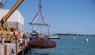 A boat in the shape of a violin, titled 'Violin of Noah', built during the pandemic by artist Livio De Marchi in collaboration with Consorzio Venezia Sviluppo and is dedicated to people who have died from coronavirus, is seen during a test-ride, in Venice