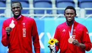 Cherif Younousse and Ahmed Tijan pose for photographs with their bronze medals.