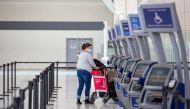 A person wearing a protective mask walks through terminal 1 at Toronto's Pearson Airport after mandatory coronavirus disease (COVID-19) testing took effect for international arrivals in Mississauga, Ontario, Canada February 15, 2021. REUTERS/Carlos Osorio