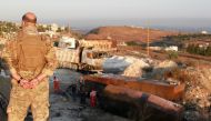 A Lebanese army soldier stands guard near the site of a fuel tank explosion in Akkar, in northern Lebanon, August 15, 2021. Reuters/Omar Ibrahim