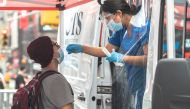 A person has a nasal swab applied for the coronavirus disease (COVID-19) test taken at a mobile testing site in Times Square in New York City, U.S., August 16, 2021. Reuters/Jeenah Moon
 