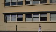 A lone pedestrian wears a face mask while walking through the city centre during a lockdown to curb the spread of an outbreak of the coronavirus disease (COVID-19) in Sydney, Australia, August 17, 2021. REUTERS/Loren Elliott
