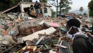 People stand near destroyed houses, after the earthquake that took place on August 14th, in Marceline, near Les Cayes, Haiti August 20, 2021. REUTERS/Henry Romero