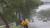 A man rides his bike in the rain after Hurricane Grace made landfall on the Yucatan Peninsula, in Merida, Mexico, August 19, 2021. REUTERS/Lorenzo Hernandez