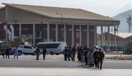 A U.S Marine leads evacuees to a U.S. Air Force C-17 Globemaster III aircraft, deployed with the 816th Expeditionary Airlift Squadron, in support of Operation Allies Refuge at Hamid Karzai International Airport in Kabul, Afghanistan, August 20, 2021.
