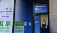  A staff member stands at the entrance of a COVID-19 clinic during a lockdown to curb a coronavirus disease outbreak in Sydney, Australia, August 20, 2021. REUTERS/Loren Elliott/File Photo