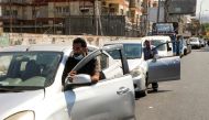 People push their cars due to a lack of fuel, near a gas station in Dora, Lebanon, August 17, 2021. Reuters/Mohamed Azakir/File Photo