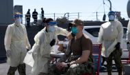 FILE PHOTO: A United States Navy officer from the amphibious ship USS San Diego (LPD 22) receives a vaccine against Coronavirus. this picture taken February 26, 2021 and released by U.S Navy on February 27, 2021. Brandon Woods/U.S. Navy/Handout via REUTER