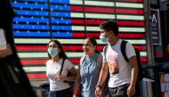 People wear masks around Times Square, as cases of the infectious coronavirus Delta variant continue to rise in New York City, New York, U.S., July 23, 2021. REUTERS/Eduardo Munoz

