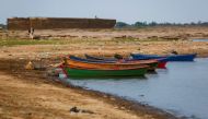 Boats are pictured on the shore of the Rio Paraguay (Paraguay River), which flows down to the Parana River, as the lack of rain in Brazil, where the river originates, has brought water levels down, forcing cargo ships to reduce the amount of grains that a