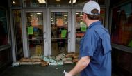 A man looks at sandbags at the entrance of a store in preparation for Hurricane Ida, in New Orleans, Louisiana, U.S. August 28, 2021. REUTERS/Marco Bello