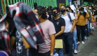 People line up to receive a dose of the Pfizer vaccine against the coronavirus disease (COVID-19) during a mass vaccination for people from 18 to 29 years old, in Xochimilco, on the outskirts of Mexico City, Mexico August 19, 2021. REUTERS/Edgard Garrido