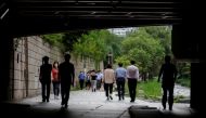 People wearing masks take a walk amid the coronavirus disease (COVID-19) pandemic in Seoul, South Korea, July 7, 2021. REUTERS/ Heo Ran