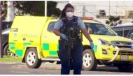 FILE PHOTO: A screen grab shows a police officer walking with a gun outside a shopping mall following a knife attack in Auckland, New Zealand September 3, 2021. TVNZ via Reuters TV/File Photo

