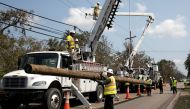 FILE PHOTO: Power restoration workers are seen in the aftermath of Hurricane Ida landfall in Louisiana, in Jean Lafitte, Louisiana, U.S. September 2, 2021. REUTERS/Marco Bello/File Photo
