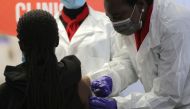 A health worker administers a vaccine during the launch of the South African leg of a global Phase III trial of Sinovac's coronavirus disease (COVID-19) vaccine in children and adolescents, in Pretoria, South Africa, September 10, 2021. REUTERS/Siphiwe Si