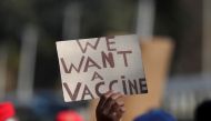 FILE PHOTO: A person holds a placard as supporters of the Economic Freedom Fighters (EFF) march to demand a rollout of coronavirus disease (COVID-19) vaccines, in Pretoria, South Africa June 25, 2021. REUTERS/Siphiwe Sibeko/File Photo
