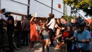 Students and parents gather in front of a school on the first day of New York City schools, amid the coronavirus disease (COVID-19) pandemic in Brooklyn, New York, U.S. September 13, 2021. REUTERS/Brendan McDermid
