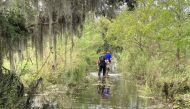 Sgt. Devin Coulon and Cpl. Chance Woods of the St. Tammany Parish Sheriff's Office searching for an alligator believed to have killed a man after Hurricane Ida in Slidell, Louisiana, in this handout picture obtained by Reuters on September 14, 2021. St. T