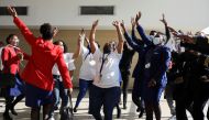 Workers sing and dance as South Africa's national airline, South African Airways (SAA), prepares to take off after a year-long hiatus triggered by it running out of funds, at O.R. Tambo International Airport in Johannesburg, South Africa, September 23, 20