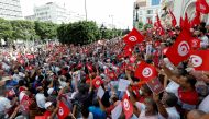 Demonstrators carry flags and banners during a protest against the Tunisian President Kais Saied's seizure of governing powers, in Tunis, Tunisia, September 26, 2021. REUTERS/Zoubeir Souissi