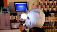 A fan of K-pop idol boy band BTS watches a live streaming online concert, wearing a protective mask to avoid the spread of the coronavirus disease (COVID-19), at a cafe in Seoul, South Korea October 10, 2020. REUTERS/Heo Ran/File Photo
