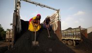 Workers unload coal from a supply truck at a yard on the outskirts of Ahmedabad, India October 12, 2021. Reuters/Amit Dave