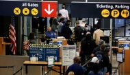 Travelers queue in a security line limited to every other lane for social distancing at Seattle-Tacoma International Airport in SeaTac, Washington, U.S. April 12, 2021. REUTERS/Lindsey Wasson