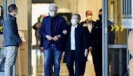 Former U.S. President Bill Clinton, accompanied by his wife, former Secretary of State Hillary Clinton, walks out of University of California Irvine Medical Center, in Orange, California, U.S. October 17, 2021. REUTERS/David Swanson