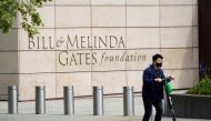 A person passes by on a scooter in front of the Bill & Melinda Gates Foundation in Seattle, Washington, U.S. May 5, 2021. REUTERS/Lindsey Wasson/File Photo