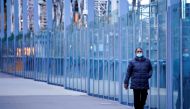 A woman wearing a protective face mask walks along a deserted city bridge during a lockdown as the state of Victoria looks to curb the spread of a COVID-19 outbreak in Melbourne, Australia, July 16, 2021. REUTERS/Sandra Sanders//File Photo/File Photo